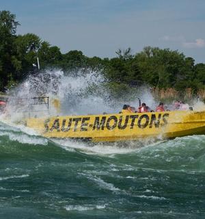 a yellow boat in the water on a river
