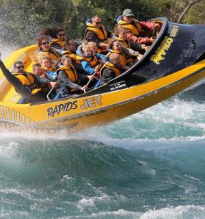 a group of people in a yellow raft in the water