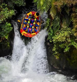 一群人在瀑布上的船上