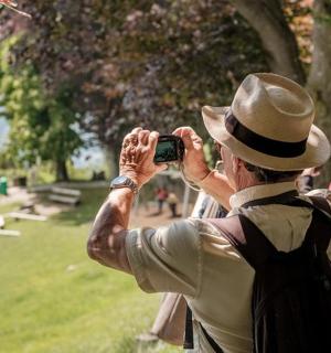a man taking a picture of a park with a camera