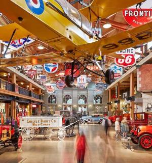 a museum with lots of cars on display in a building