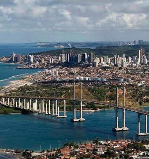a bridge over a body of water with a city