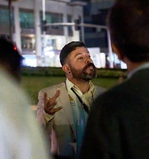 a man in a suit talking to two men