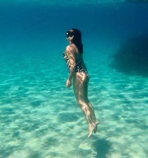 a woman standing in the water in the ocean