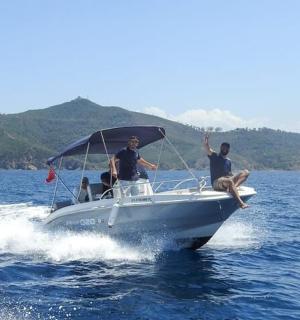 three men on a boat in the water