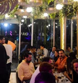 a group of people sitting in a restaurant