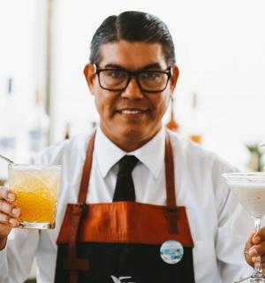 a man holding a drink and a martini