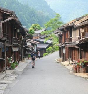 a man walking down a street in a village