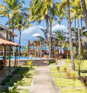 a resort with a swimming pool and palm trees