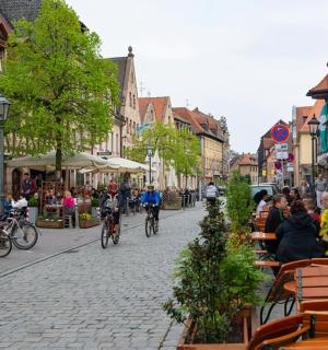 a group of people riding bikes down a city street