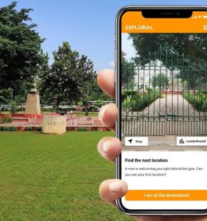 a person holding up a cell phone in a park