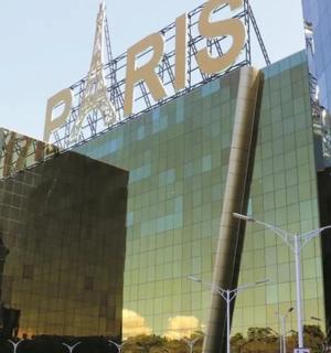a glass building with a sign on top of it