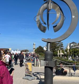 a woman is standing next to a street sign