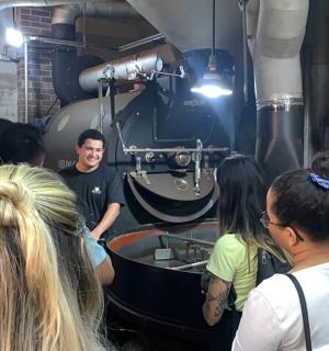 a group of people standing around a man in a machine