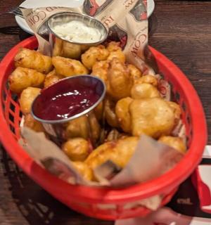a red basket filled with food on top of a table