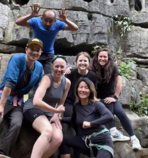 a group of people posing for a picture on some rocks