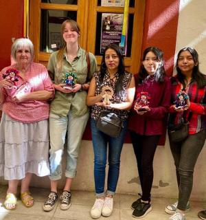 a group of women standing in front of a building