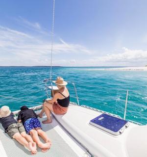 a group of people sitting on a boat in the water