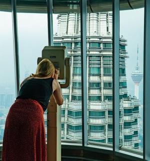 a woman standing in an office looking out the window