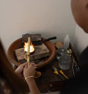 a man lighting a candle on a table