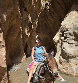 a man riding a horse through a river