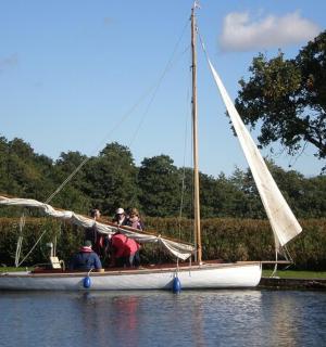 a group of people on a sail boat in the water