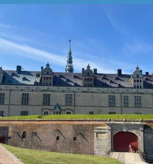 a large building with a red door and turrets