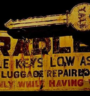 a yellow sign that has a gun on it