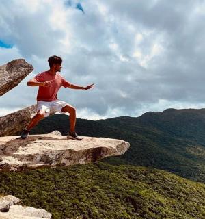 a man standing on the edge of a rock