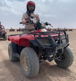 一名男子在沙漠中驾驶四轮车