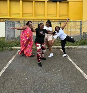 a group of girls dancing in a parking lot