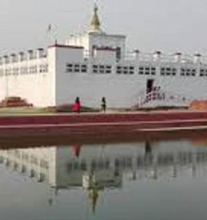 a large white building with a reflection in the water