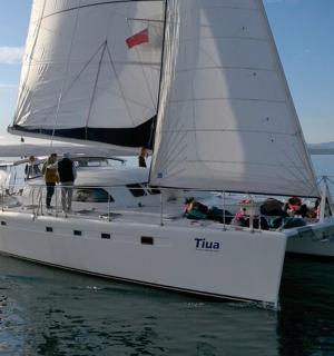 a group of people on a sail boat in the water