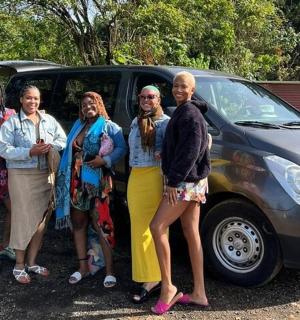 a group of people standing in front of a van