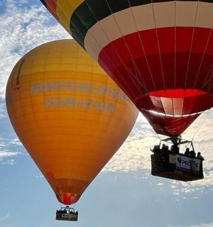 two hot air balloons flying in the sky