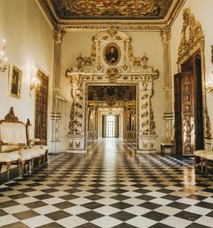 an ornate room with two chairs and a large door