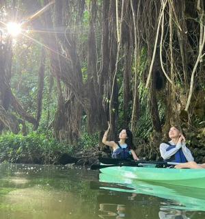 two women sitting in a boat in the water