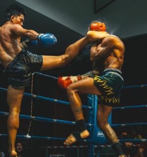 two men are fighting in a boxing match