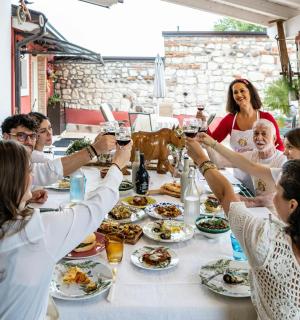 a group of people sitting around a table drinking wine