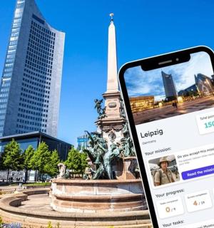 a cell phone in front of a statue in a city