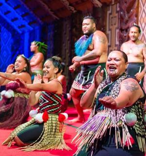 a group of people singing and dancing in a performance