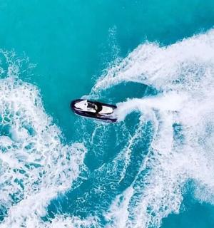 a boat in the middle of a wave in the ocean