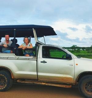 two people sitting in the back of a white truck