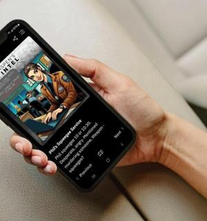 a person holding a cell phone with a book on it