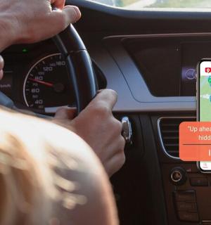 a person driving a car with a cell phone in a car