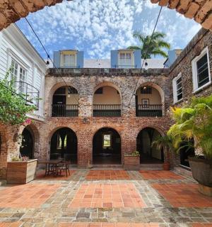 an archway of a brick building with a courtyard