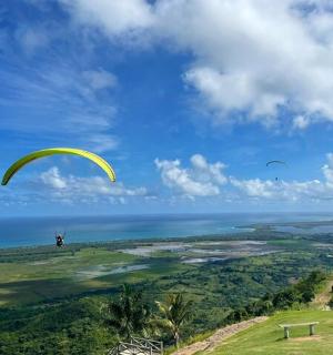 a person is flying a parachute over the ocean