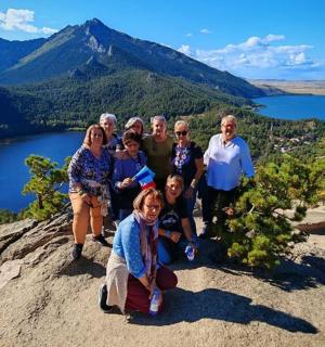 a group of people standing on top of a mountain