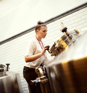 a woman standing in a kitchen preparing food