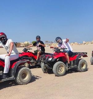 a group of people riding atvs on the beach